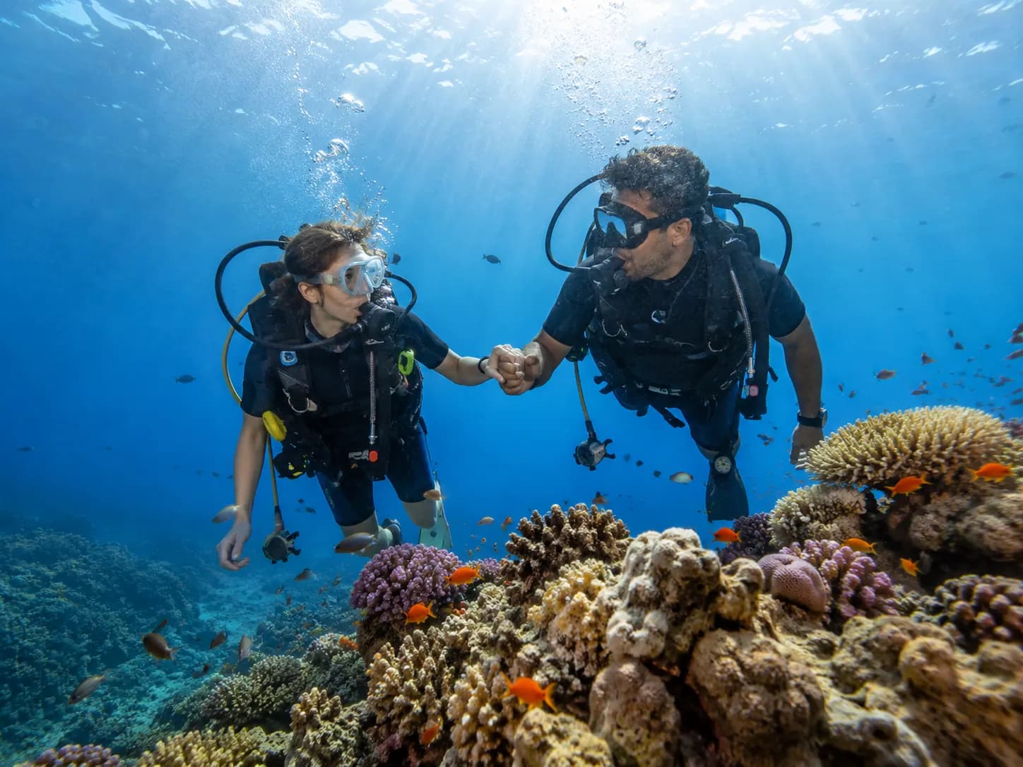 First time diver trying scuba diving with an instructor in the Red Sea